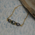 Black freshwater pearl paperclip chain bracelet with large gold roundels