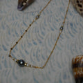 Tahitian pearl necklace with gold roundels on a starburst chain